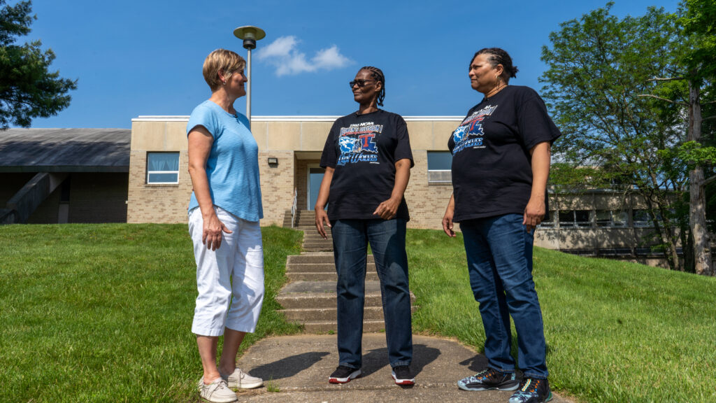 Brenda VanLengen, Val Walker and Yolanda Laney stand together and talk on the Cheyney State campus.